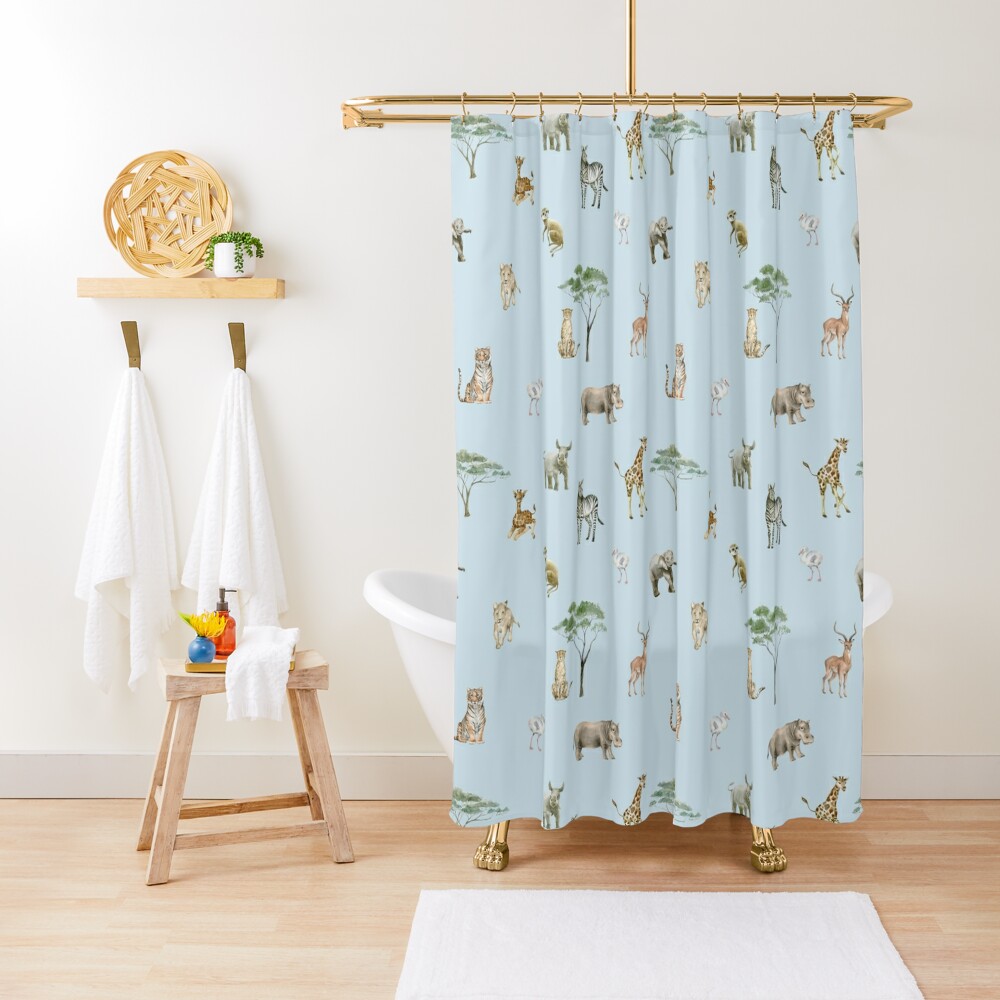 A shower curtain with safari animal and trees on a light blue background